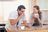 Couple drinking coffee in the kitchen