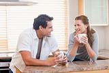 Couple enjoying coffee in the kitchen together