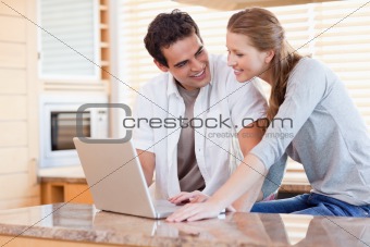 Couple with laptop in the kitchen