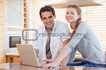 Couple with notebook in the kitchen