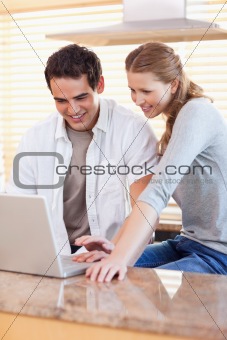 Couple surfing the web in the kitchen