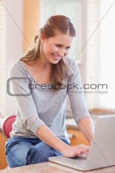 Woman surfing the web in the kitchen