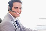 Side view of smiling businessman with headset on