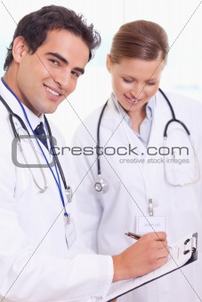 Assistant doctors with patient record