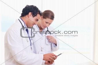 Medical staff looking at clip board
