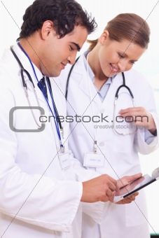 Young assistant doctors using tablet