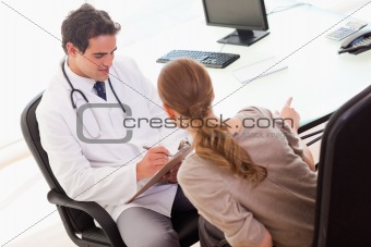 Patient describing symptoms to her doctor