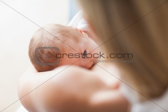 Above view of newborn getting breastfed