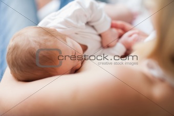 Newborn getting suckled