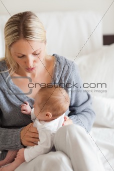 Affectionate mother with newborn on her lap