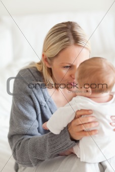 Affectionate mother with baby on her lap
