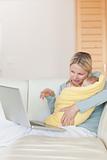 Mother on the couch showing her baby something on the laptop