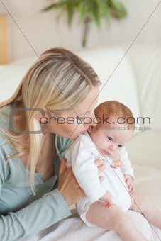 Mother on the sofa holding her baby