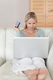 Woman on the sofa booking flight online