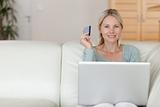 Woman on the couch booking holidays online
