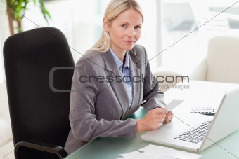 Side view of businesswoman doing her accounting