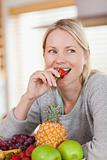 Close up of woman eating a strawberry