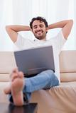 Portrait of a happy man using a laptop