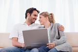 Happy couple using a laptop