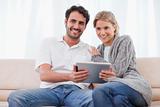 Smiling couple using a tablet computer