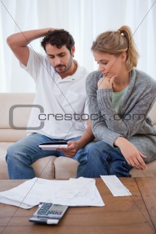 Portrait of a couple looking at their bills