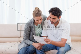Focused couple reading a letter