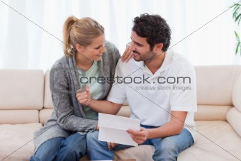 Happy couple reading a letter