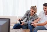 Laughing couple playing video games