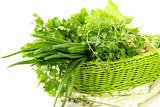 fresh green grass parsley dill onion herbs mix in a wicker basket