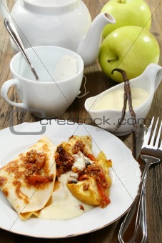 Pancakes with baked apples and vanilla sauce.