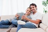 Happy young couple using a tablet computer