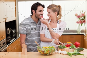 Lovely couple slicing pepper