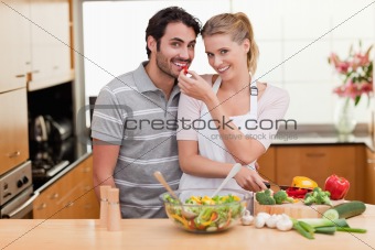 Young couple slicing pepper