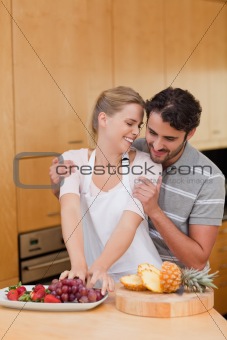 Portrait of a lovely couple eating fruits