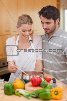Portrait of a couple preparing a sauce