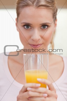 Portrait of a young woman drinking juice