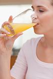 Portrait of a calm woman drinking orange juice