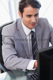 Portrait of a young businessman working with a computer