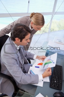 Portrait of a manager and her secretary looking at a graph