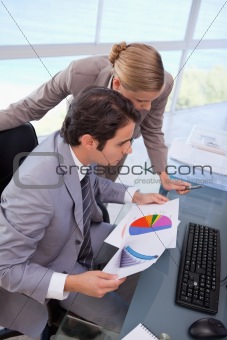 Portrait of a business team looking at a graph