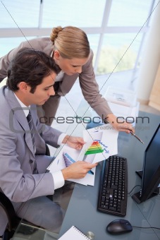 Portrait of a focused business team looking at a graph