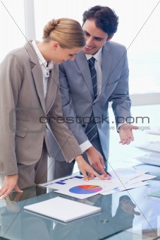 Portrait of smiling business people looking at statistics