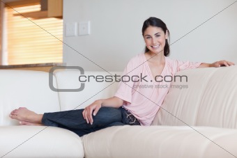 Smiling woman sitting on a sofa