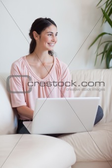 Portrait of a smiling woman using a notebook