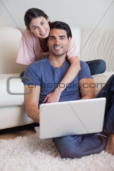 Portrait of a lovely couple using a laptop