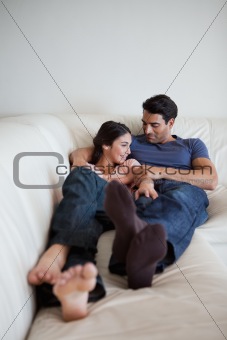 Portrait of a couple lying on a couch