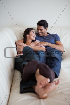 Portrait of a young couple lying on a sofa