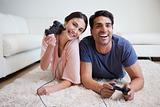 Delighted couple playing video games