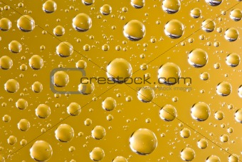 Abstract water drops over yellow background
