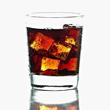 Fresh Cold Cola with ice in glass isolated on white background